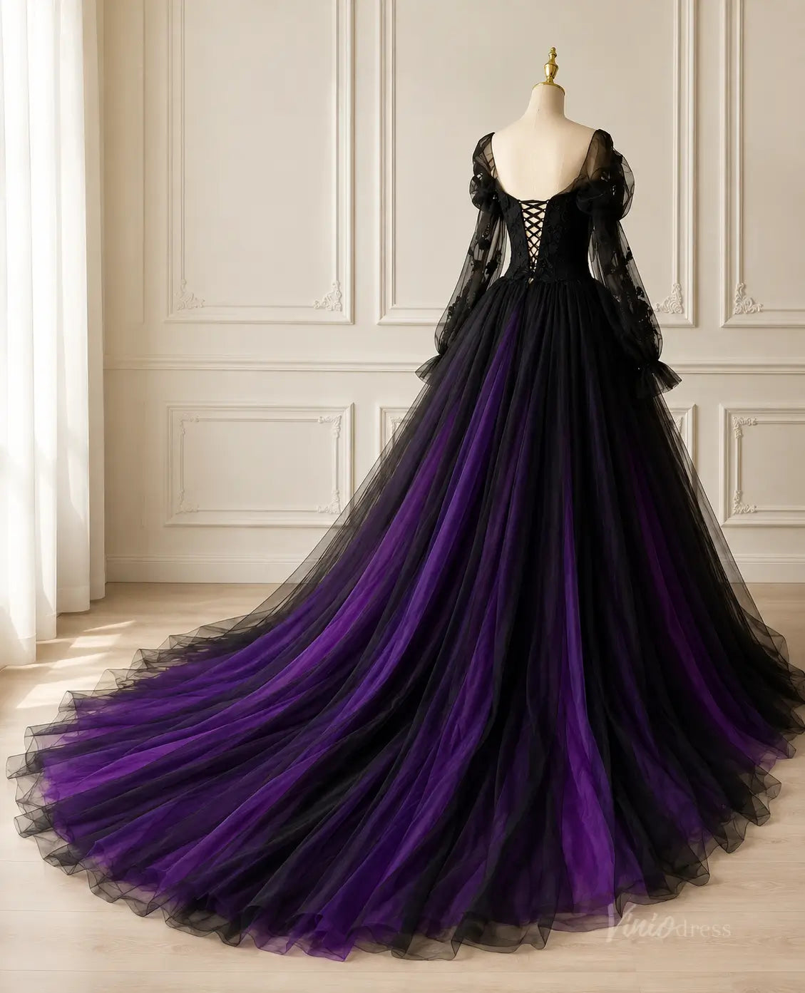 Black and purple tulle ball gown with long sheer sleeves, lace-up corset back, and a dramatic floor-length train.