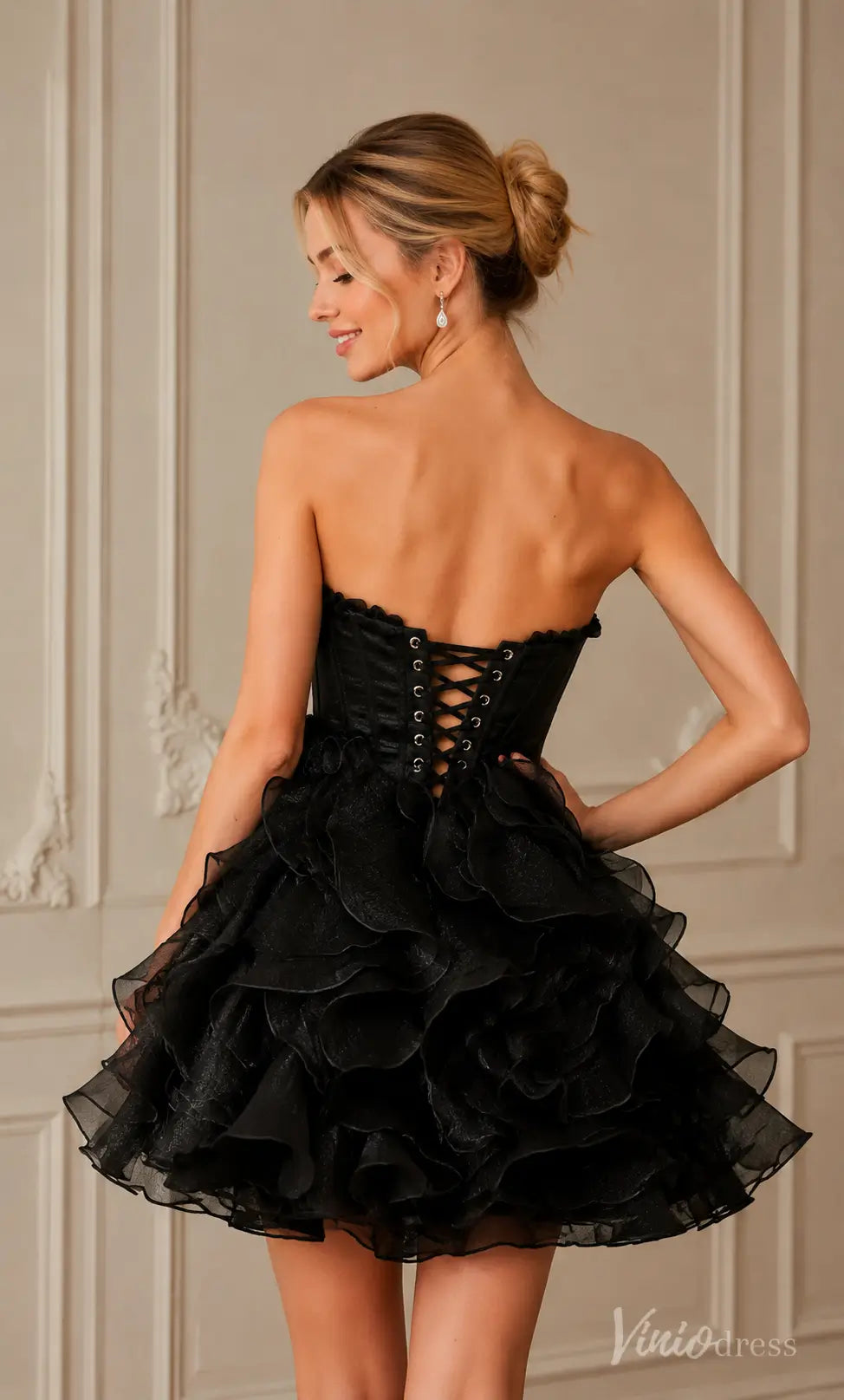 Black strapless wrinkled organza mini dress with a corset lace-up back and ruffled skirt.