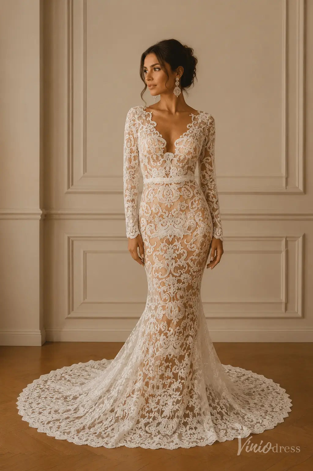 Long-sleeve mermaid wedding dress in white lace with a deep V-neckline and a dramatic floor-length train.