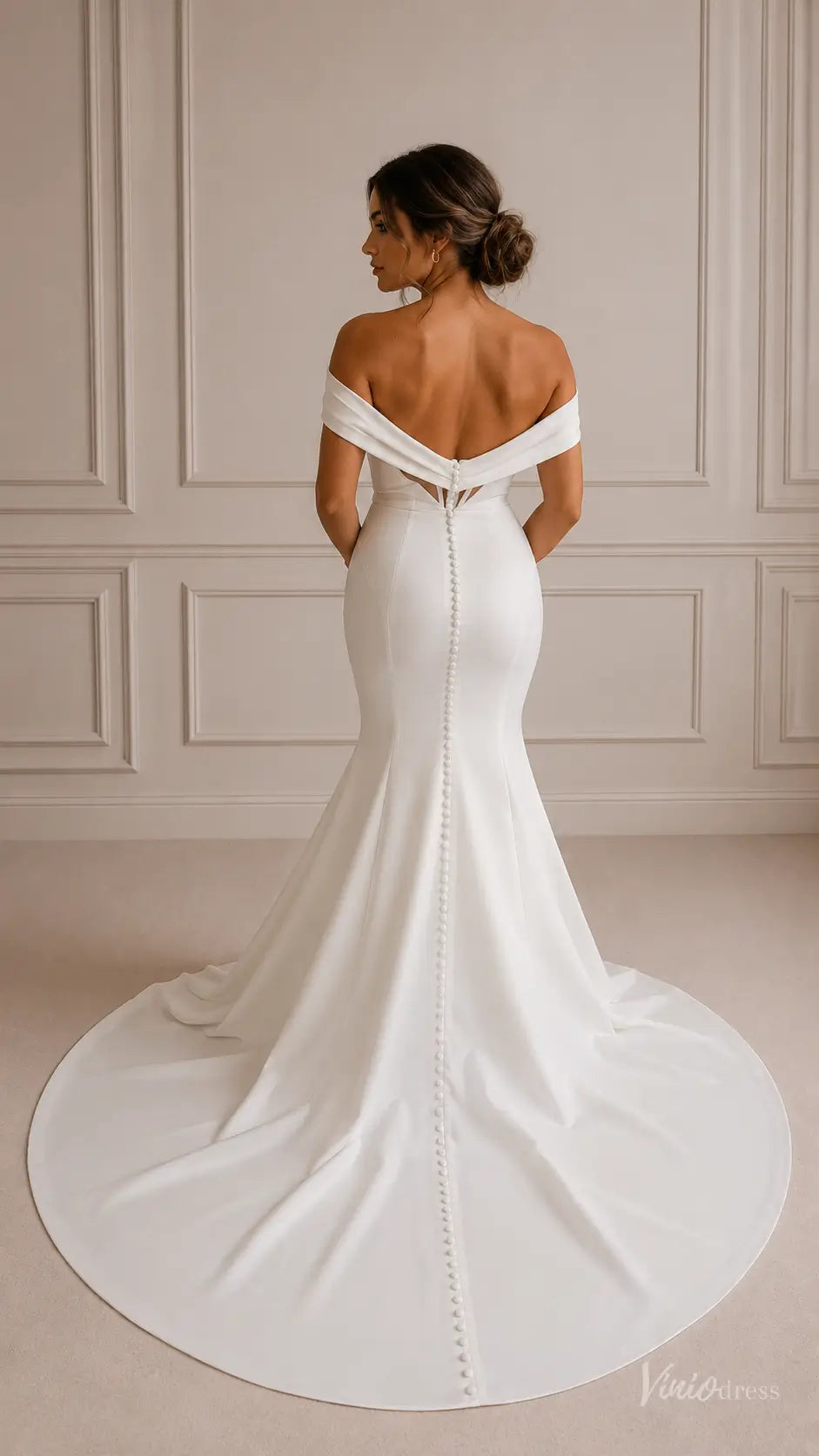 Minimalist white crepe mermaid wedding dress with off-shoulder folded neckline and a button-down train.