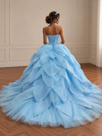 Light blue strapless Quinceañera dress with a glittery corset back and a dramatic, removable petal-layered skirt.