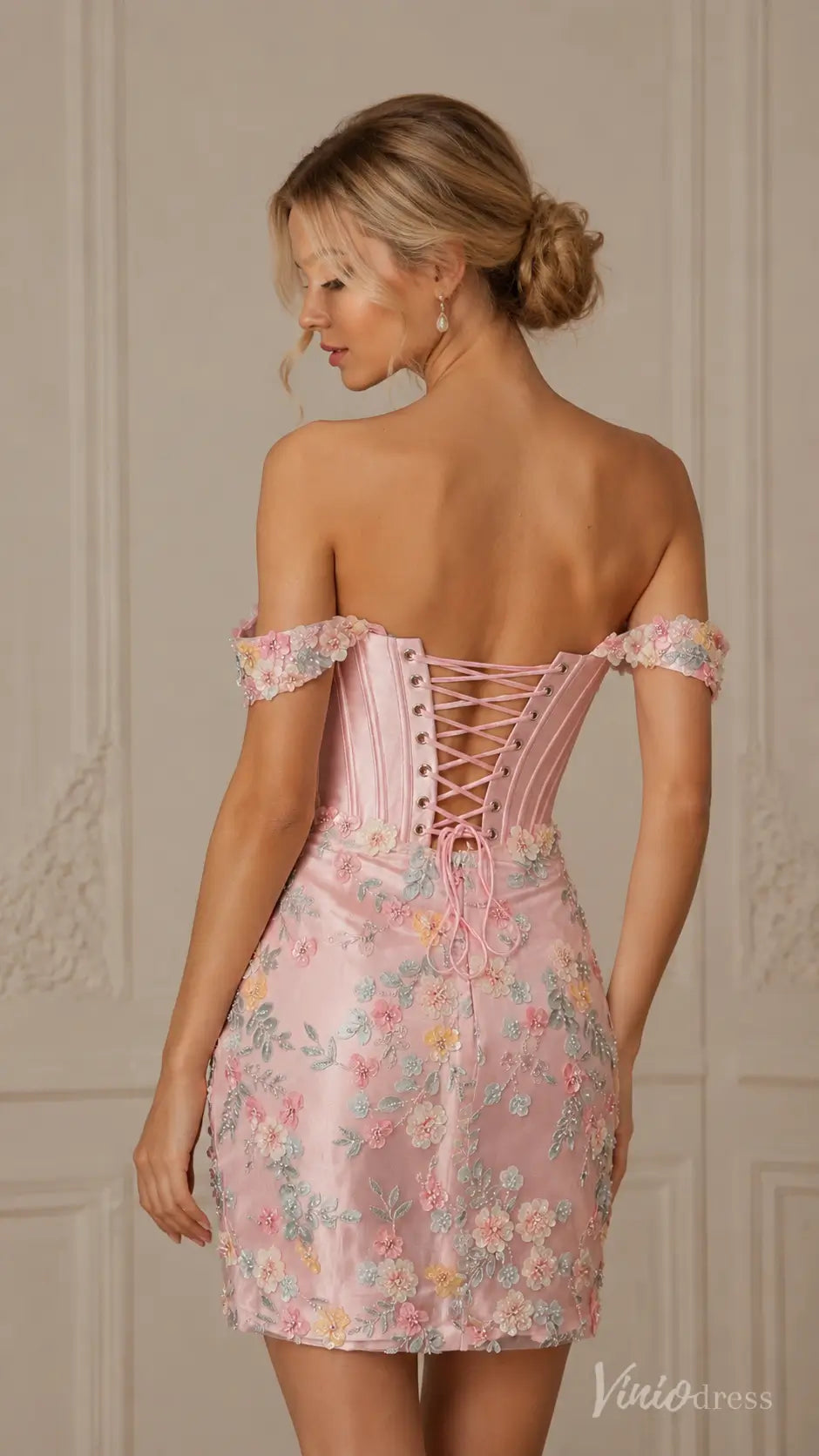Pink off-shoulder mini dress with floral embroidery and a lace-up corset back.