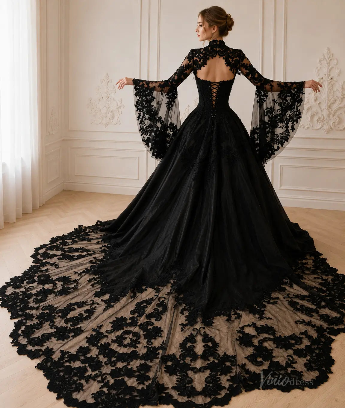 Black gothic wedding dress with long lace bell sleeves, corset back, and an elaborate floor-length train with floral embroidery.