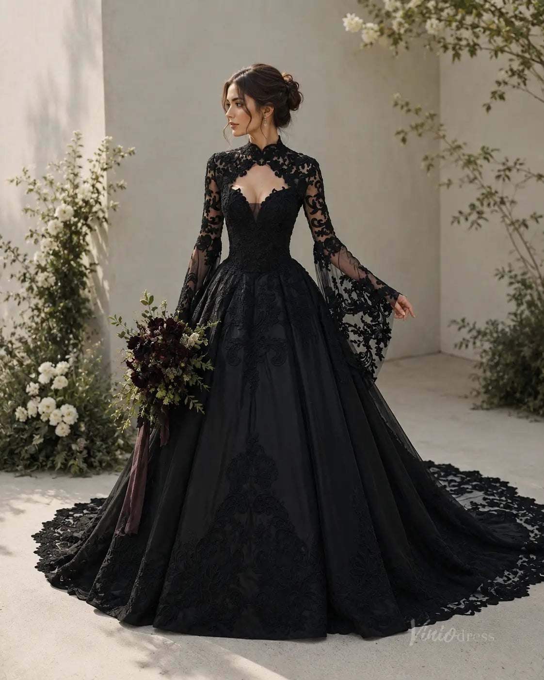 Black gothic wedding dress with long lace sleeves, high neckline, and a voluminous tulle skirt with intricate embroidery.