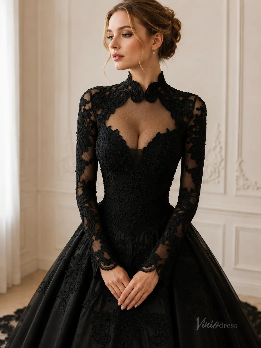 Black long-sleeve ball gown with intricate lace embroidery, high neckline, and a sheer illusion bodice.