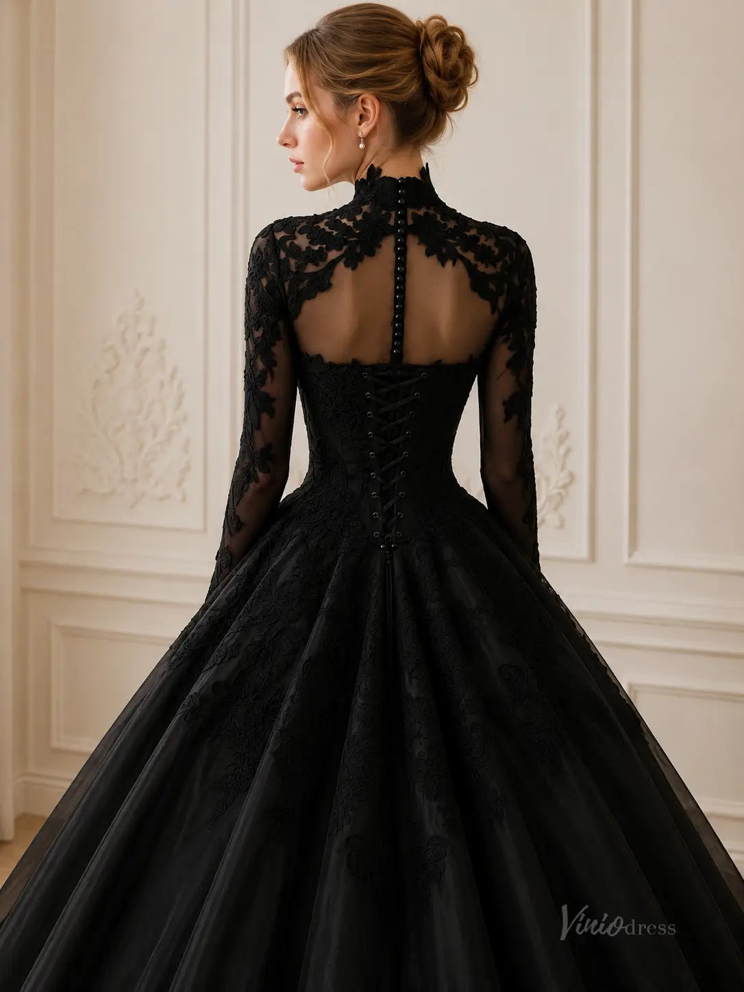 Black lace ball gown with high neck, long sleeves, sheer illusion back, and corset-style lace-up closure.