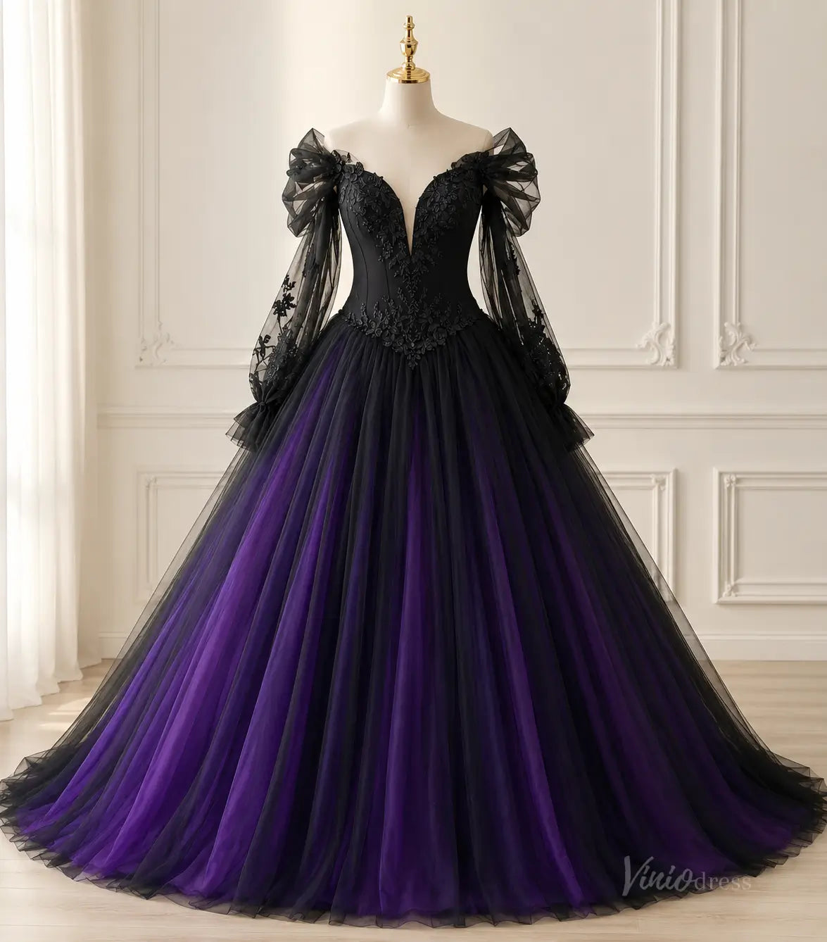 Black and purple ball gown with off-the-shoulder sheer sleeves, lace bodice, and a voluminous layered tulle skirt.