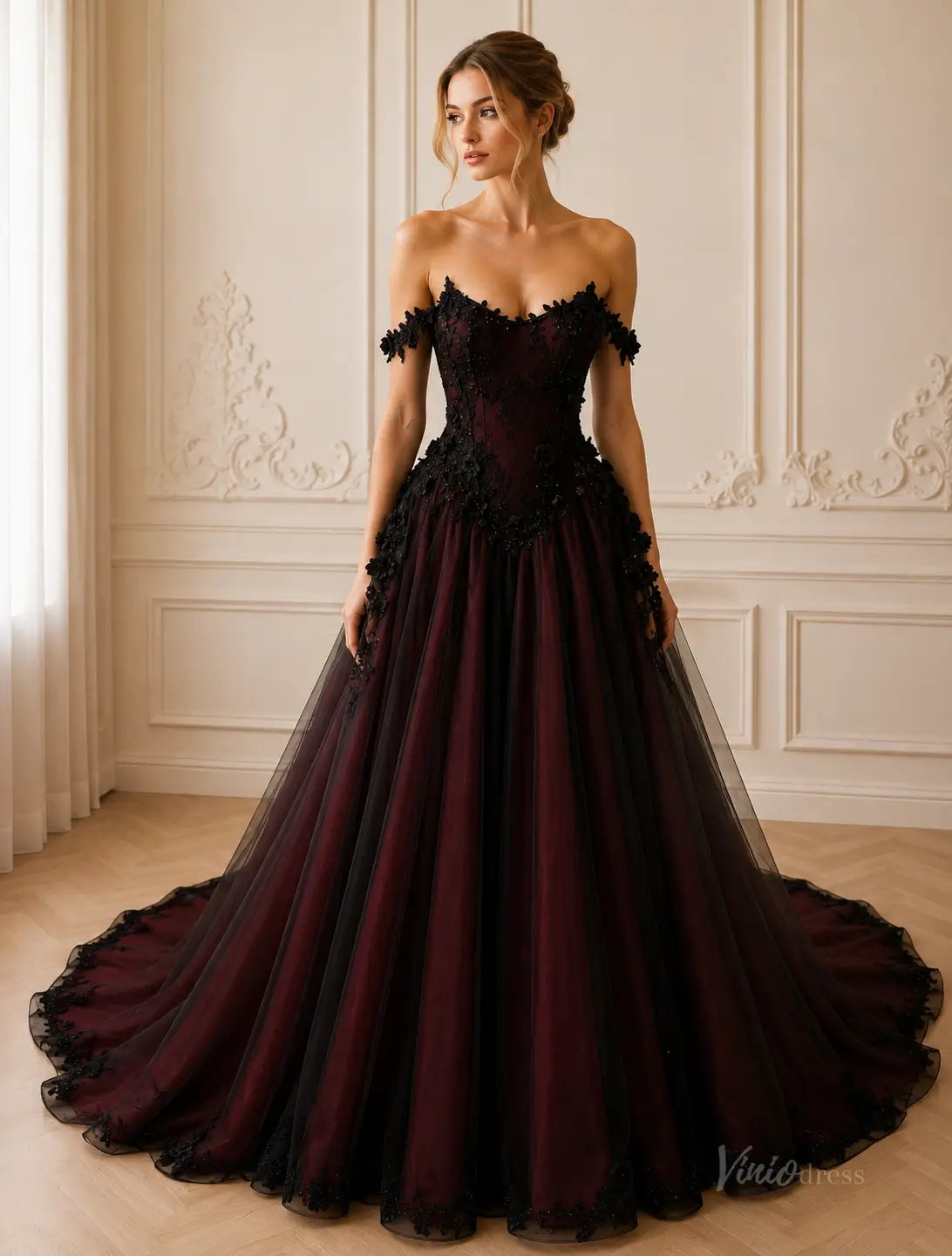 Off-the-shoulder ball gown in deep burgundy and black tulle with intricate floral lace bodice and a dramatic floor-length train.