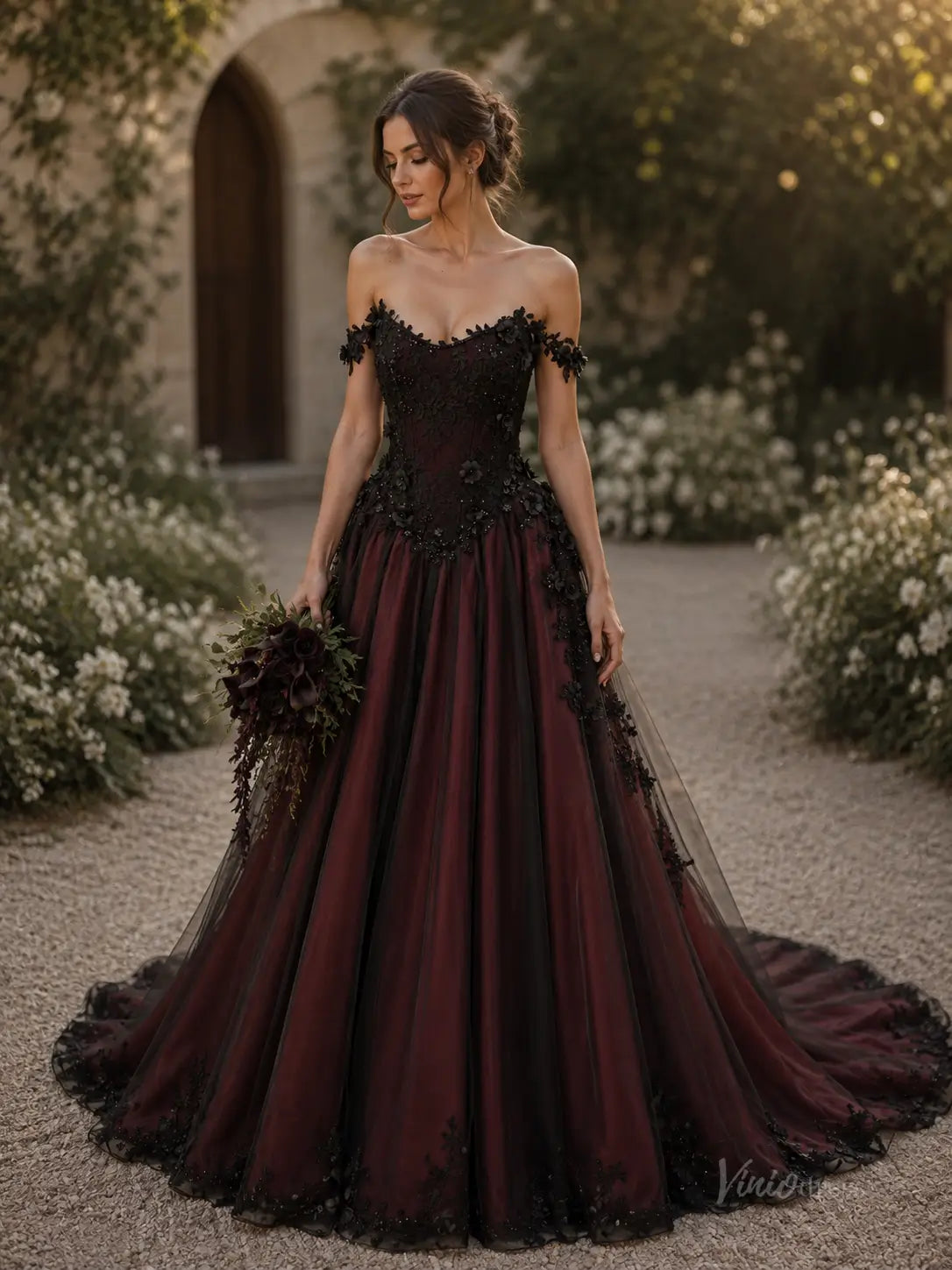 Off-the-shoulder ball gown in deep burgundy and black tulle with intricate lace appliqué and a full, flowing skirt.