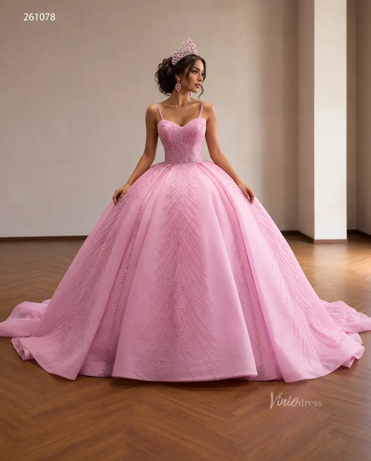 Pink quinceañera ball gown with sequin corset bodice, spaghetti straps, and beaded leaf-pattern skirt.
