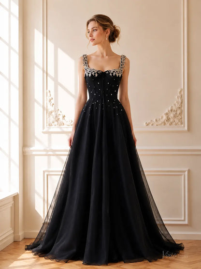 Black tulle A-line prom dress with a square neckline, crystal-embellished straps, and a structured corset bodice.