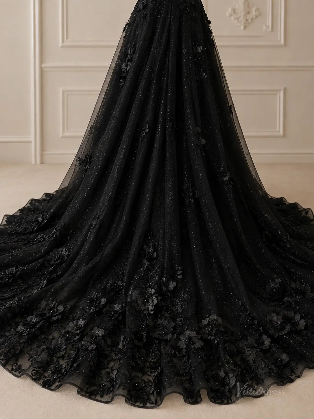 Black glitter tulle A-line wedding dress with 3D floral appliqué and a flowing chapel-length train.