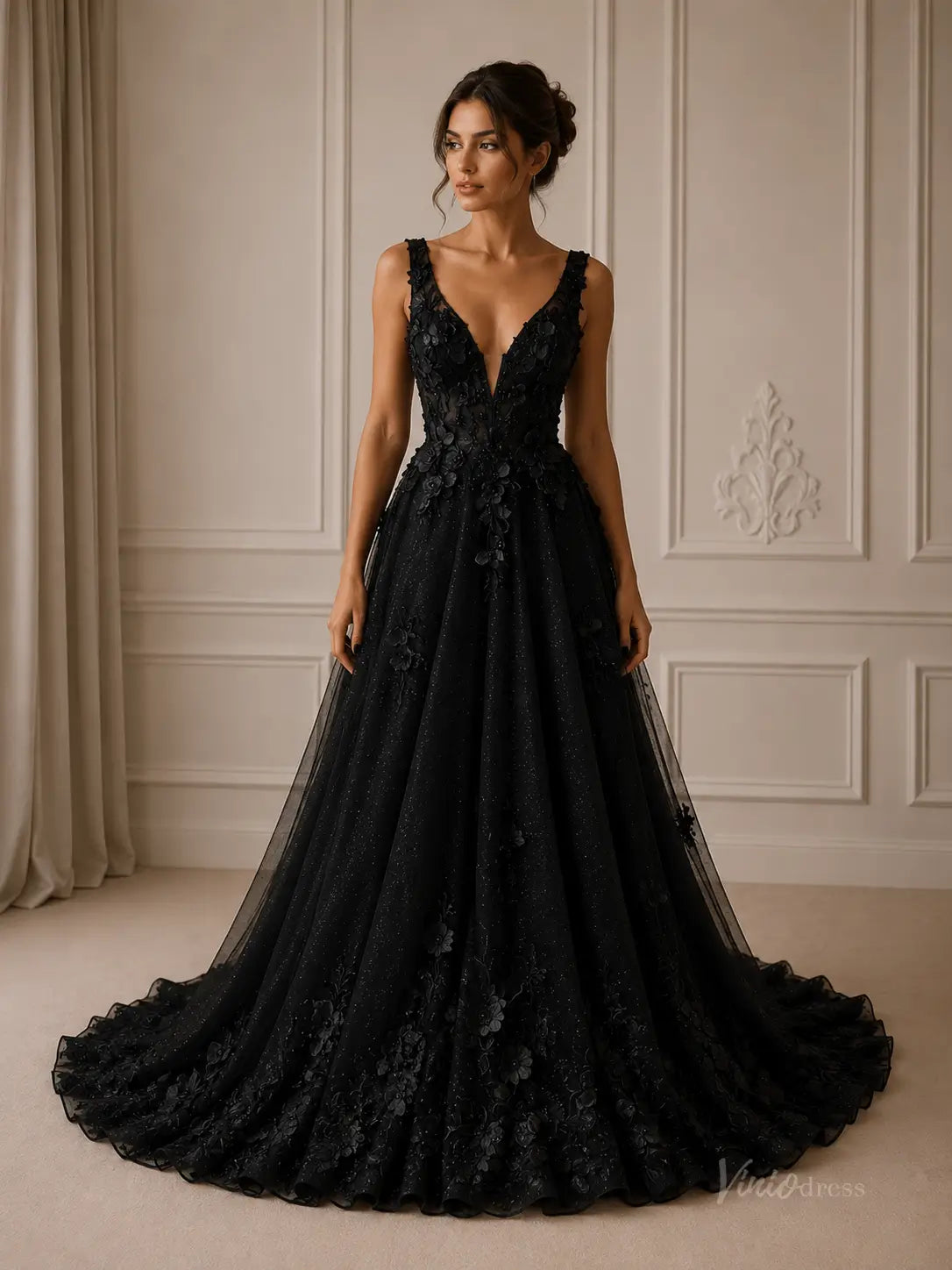 Black A-line wedding dress in glitter tulle with deep V-neckline and 3D floral appliqué and chapel train.