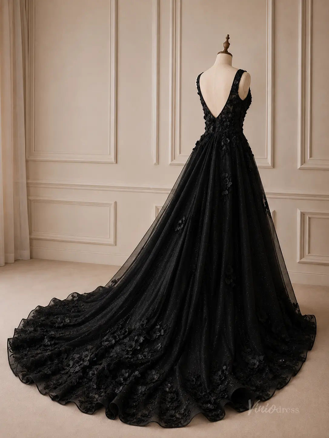 Black A-line wedding dress in glitter tulle with 3D floral appliqué, deep V-back, and a long chapel train.