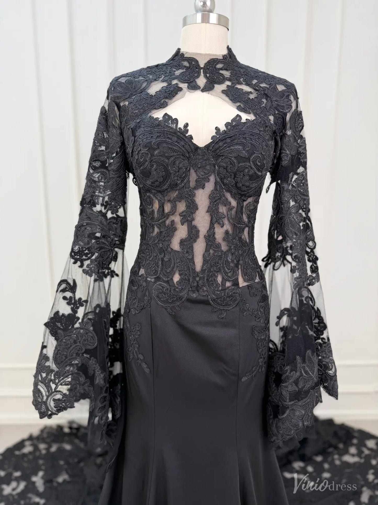 Black mermaid wedding dress with a sweetheart neckline and removable sheer lace long sleeve overlay with high neck.