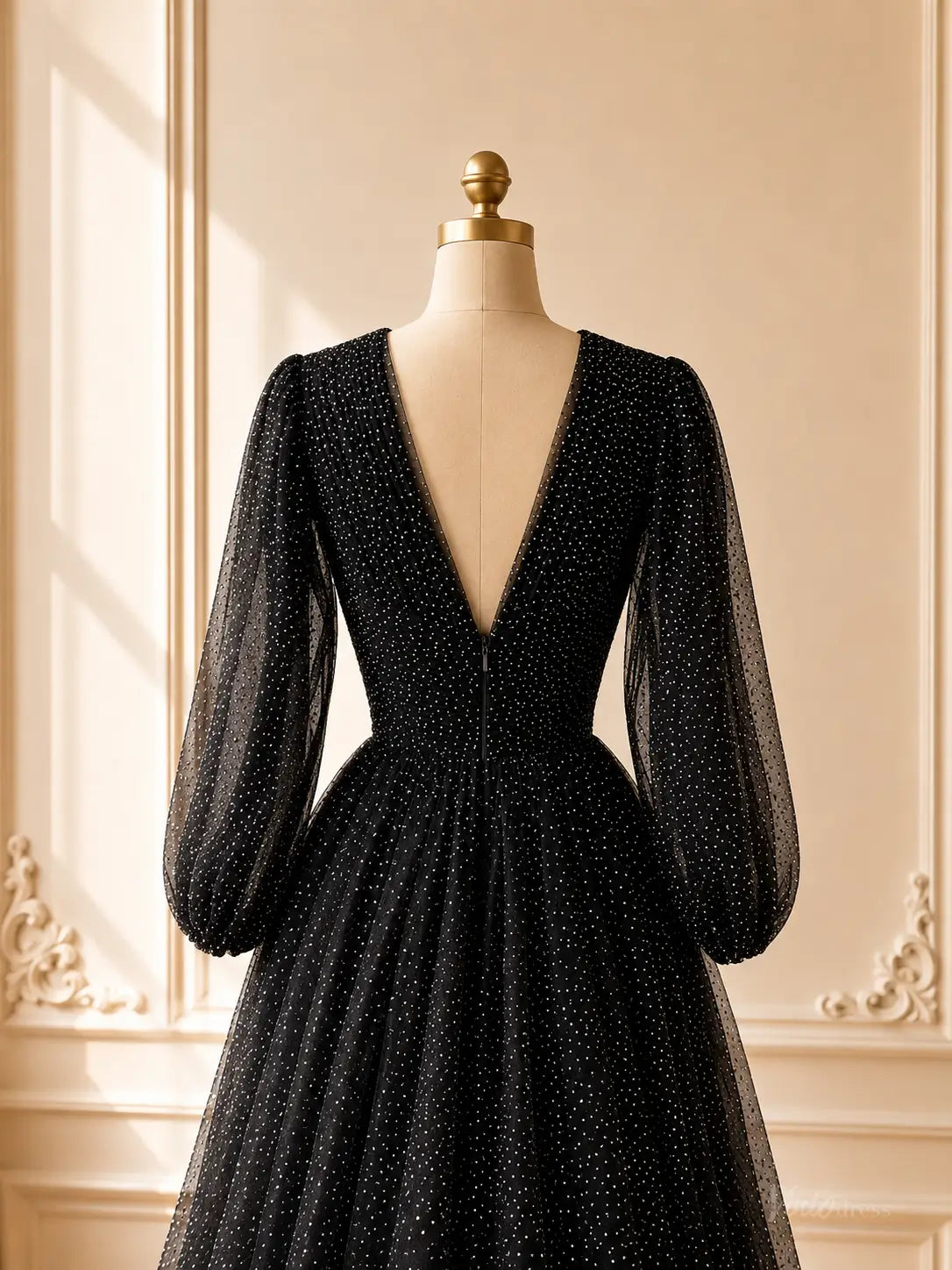Black sparkly tulle prom dress with sheer bishop sleeves and a deep V-back on a mannequin.