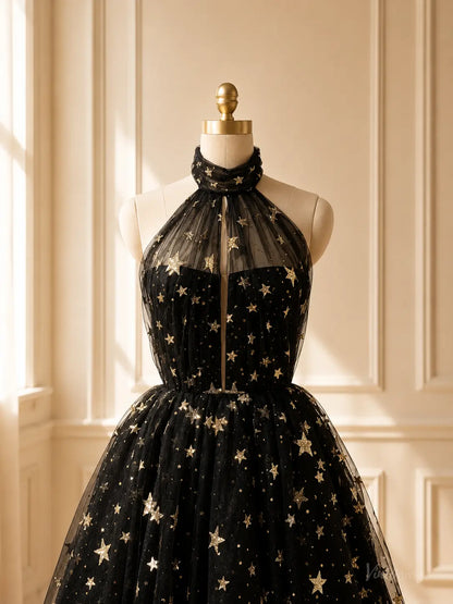 Black tulle tea-length prom dress with gold star embellishments, halter neckline, and sheer illusion bodice.