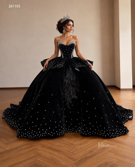 Black velvet quinceañera ball gown with crystal corset, ruffle peplum, beaded leaf embroidery, and a sweeping train.