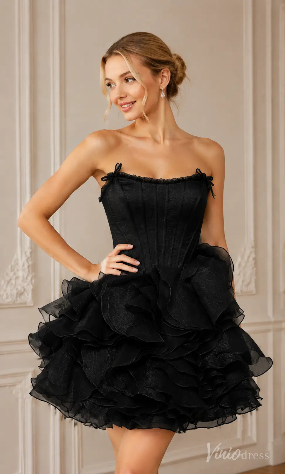 Black strapless wrinkled organza mini dress with ruffled skirt and corset bodice.
