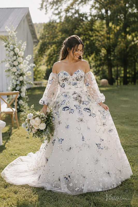 Blue floral embroidered A-line wedding dress with off-the-shoulder puff sleeves and a sweetheart bodice in a garden setting.