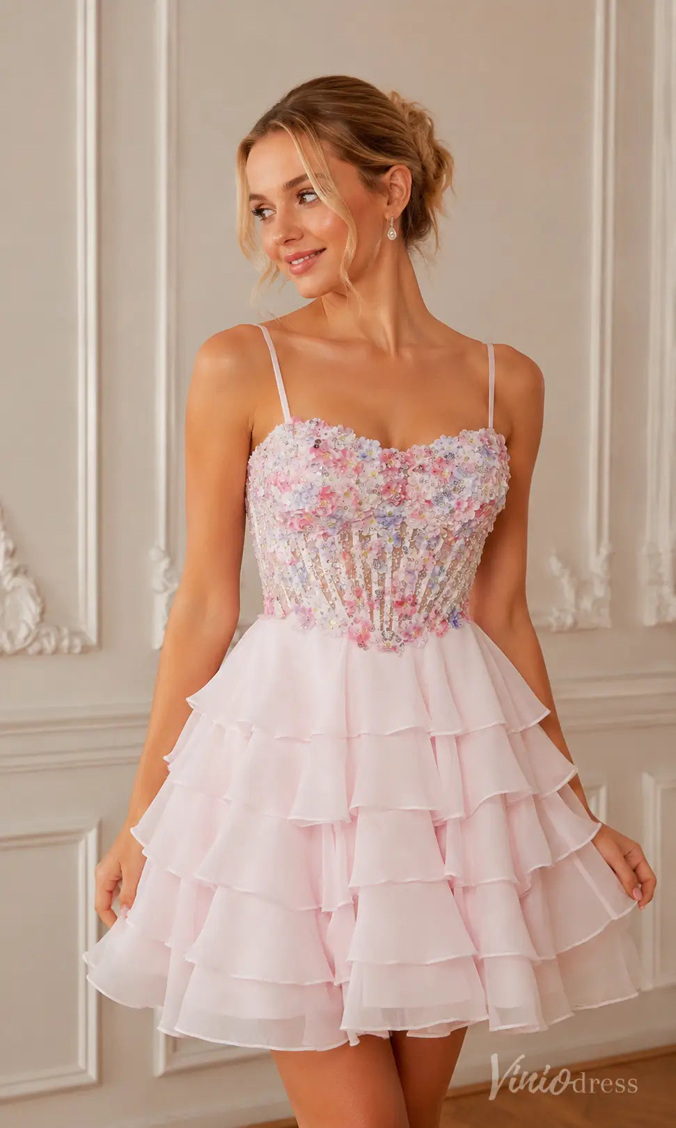 Pink tiered mini dress with a floral beaded bodice and spaghetti straps.