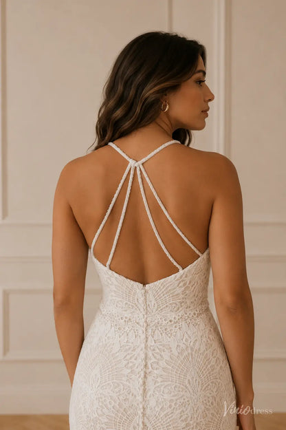 White lace wedding dress with a low back, delicate spaghetti straps, and elegant button-down detailing.