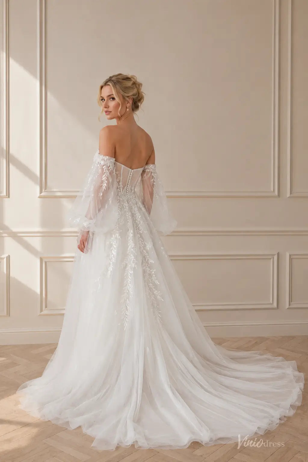 Boho wedding dress with puff sleeves, pleated bodice, floral lace appliqués, and a flowing chapel train.