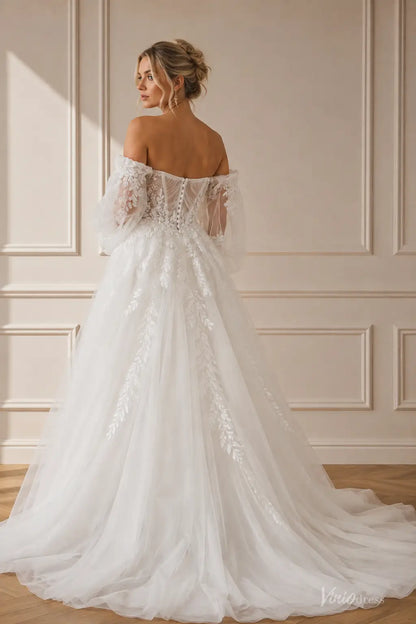 Boho wedding dress with puff sleeves, pleated bodice, floral lace appliqués, and a flowing chapel train in white tulle.