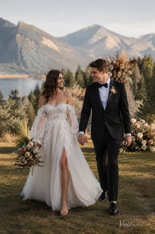 Boho wedding dress with puff sleeves, pleated bodice, floral lace appliqués, and a flowing skirt with a chapel train.