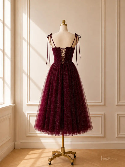 Burgundy tea-length glitter tulle prom dress with tie straps and a lace-up corset back on a mannequin.