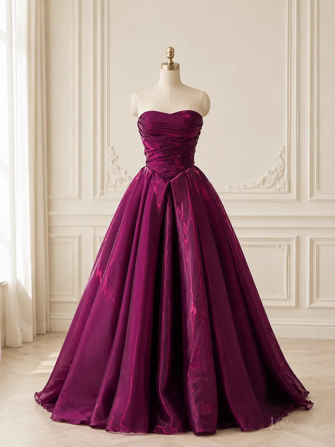 Burgundy plum shiny satin ball gown with a strapless ruched bodice, sweetheart neckline, and voluminous A-line skirt.