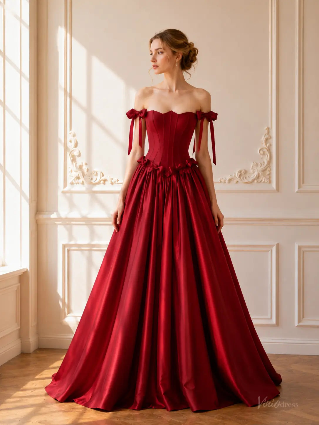 Burgundy satin ball gown with a corset bodice, basque waist, and off-the-shoulder bow straps.