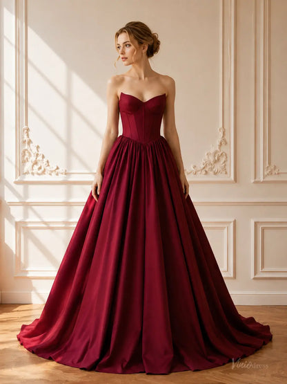 Burgundy satin ball gown with a strapless sweetheart corset bodice and a dramatic floor-length gathered skirt.