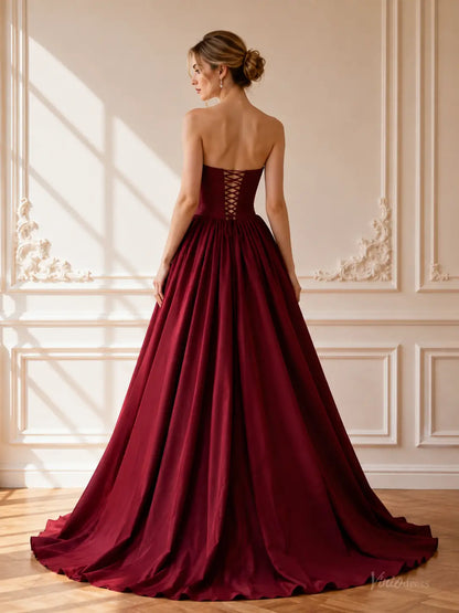 Burgundy satin ball gown with a strapless corset bodice, basque waist, and lace-up back in a floor-length formal style.