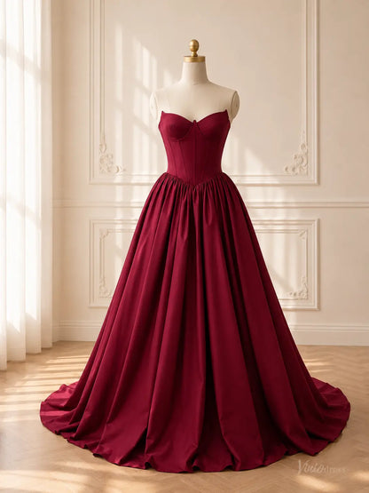Burgundy satin ball gown with a strapless sweetheart corset bodice and a dramatic, voluminous gathered skirt.
