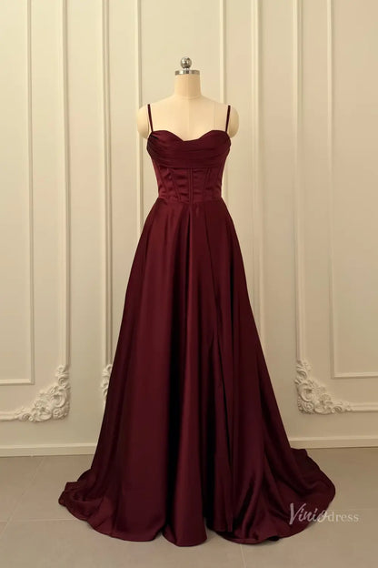 Burgundy satin prom dress with a corset bodice, sweetheart neckline, and spaghetti straps on a mannequin.
