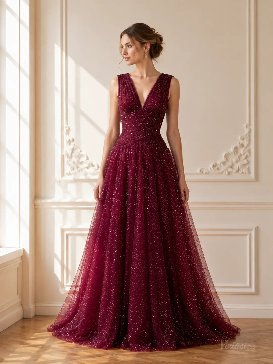 Burgundy sparkly tulle A-line prom dress with a deep V-neck, ruched bodice, and floor-length flowing skirt.