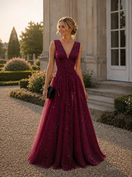 Burgundy sparkly tulle A-line prom dress with a deep V-neck, ruched bodice, and floor-length flowing skirt.