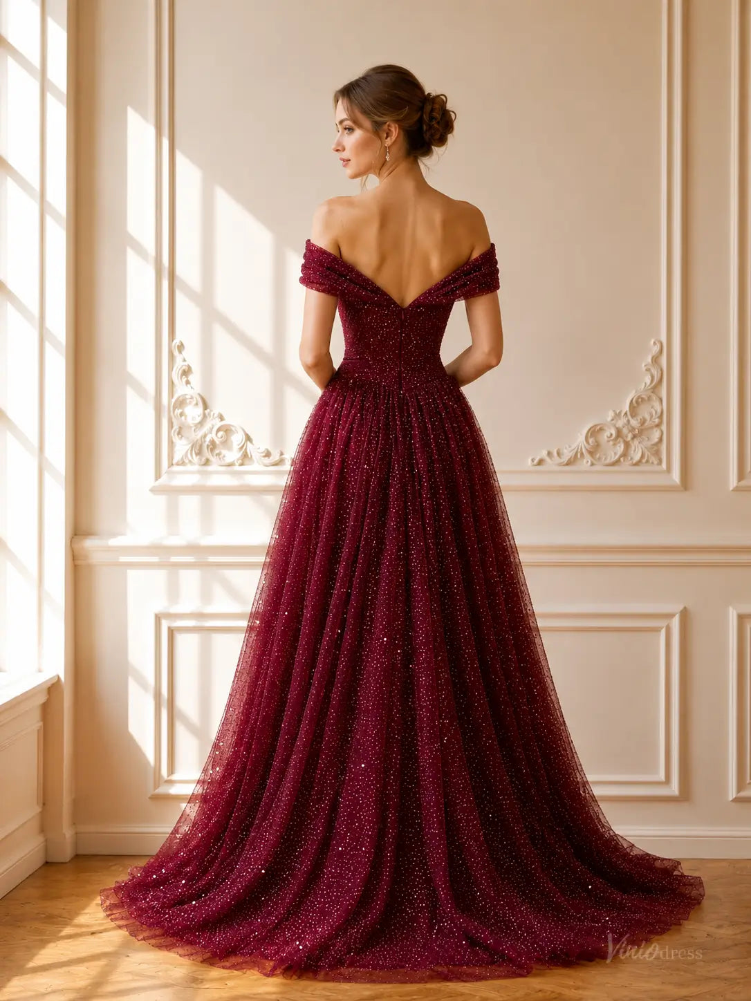 Burgundy sparkly tulle ball gown with off-shoulder neckline, ruched bodice, and floor-length skirt with a sweeping train.