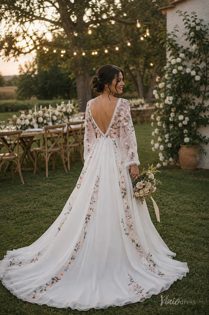 Back view of a long-sleeve chiffon wedding dress with floral embroidery, a deep V-back, and an airy A-line skirt in a garden.