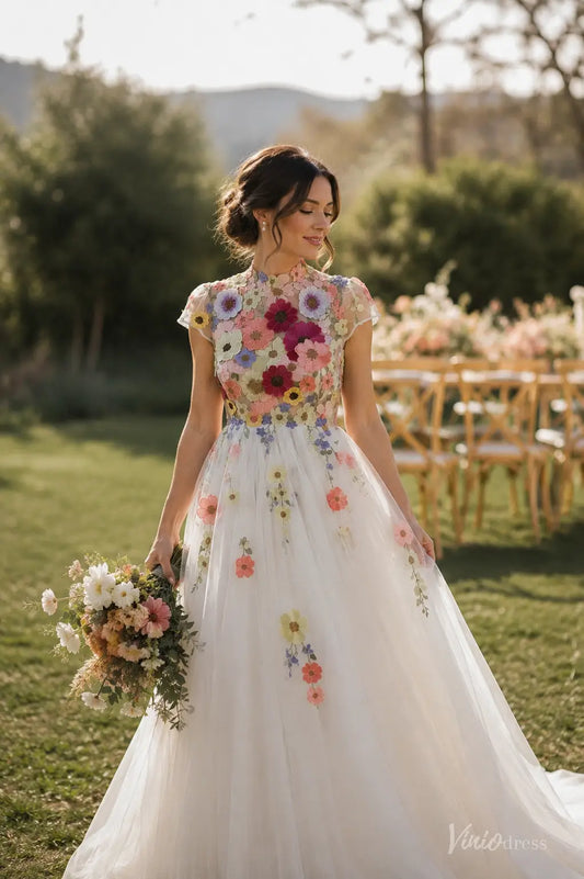 Knee-length wedding dress with colorful floral embroidery, high neck, cap sleeves, and a whimsical tulle A-line skirt.