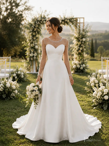 MN174 A-line wedding dress with long sheer beaded sleeves, sweetheart bodice, and a flowing satin skirt in an outdoor setting.