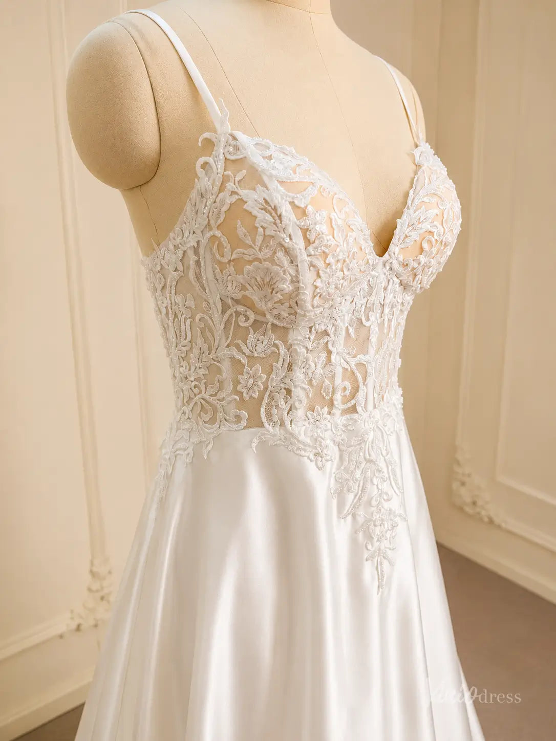 White satin wedding dress with a sheer lace appliqué bodice and sweetheart neckline.