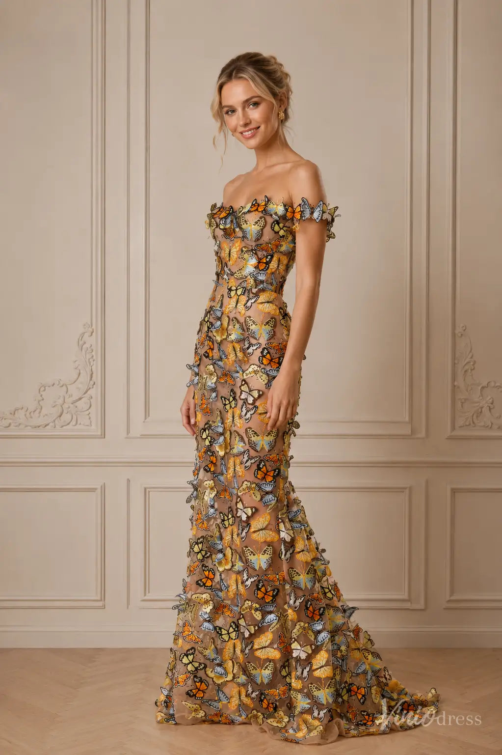 Off-the-shoulder floor-length gown featuring sheer fabric adorned with colorful 3D butterfly appliqués.