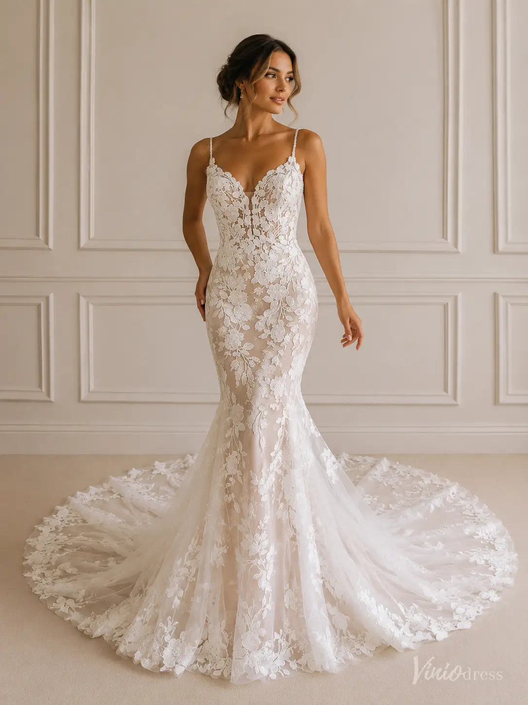 Ivory mermaid wedding dress with 3D floral lace, deep V-neck, spaghetti straps, and a sheer corset bodice with a train.