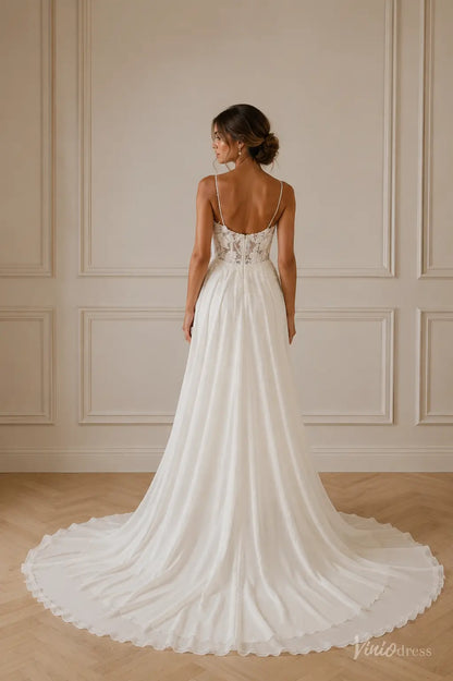 Back view of a white chiffon wedding dress with a lace bodice, thin spaghetti straps, and a flowing floor-length train.