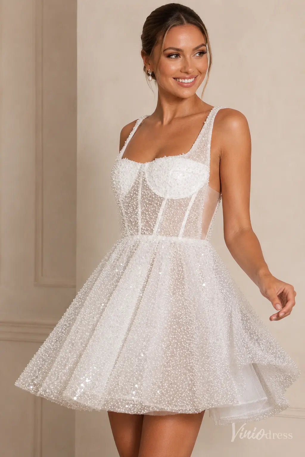 Short white wedding dress with a square neckline, pearl-beaded sheer tulle, and a structured corset bodice.