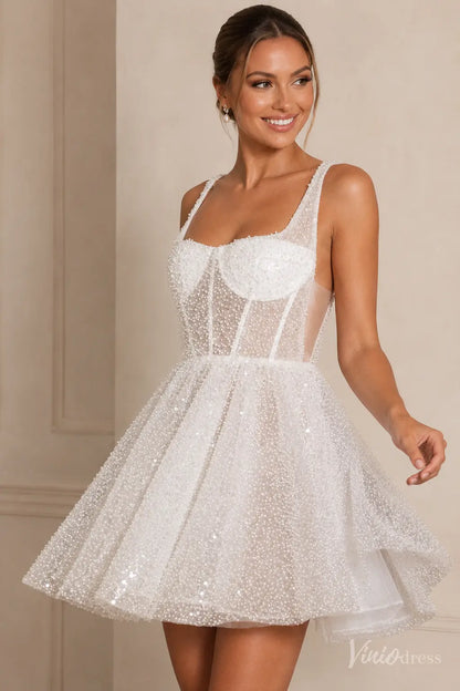 Short white wedding dress with a square neckline, pearl-beaded sheer tulle, and a structured corset bodice.