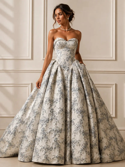 Dusty blue jacquard wedding ball gown with a strapless sweetheart bodice and a full, pleated skirt.