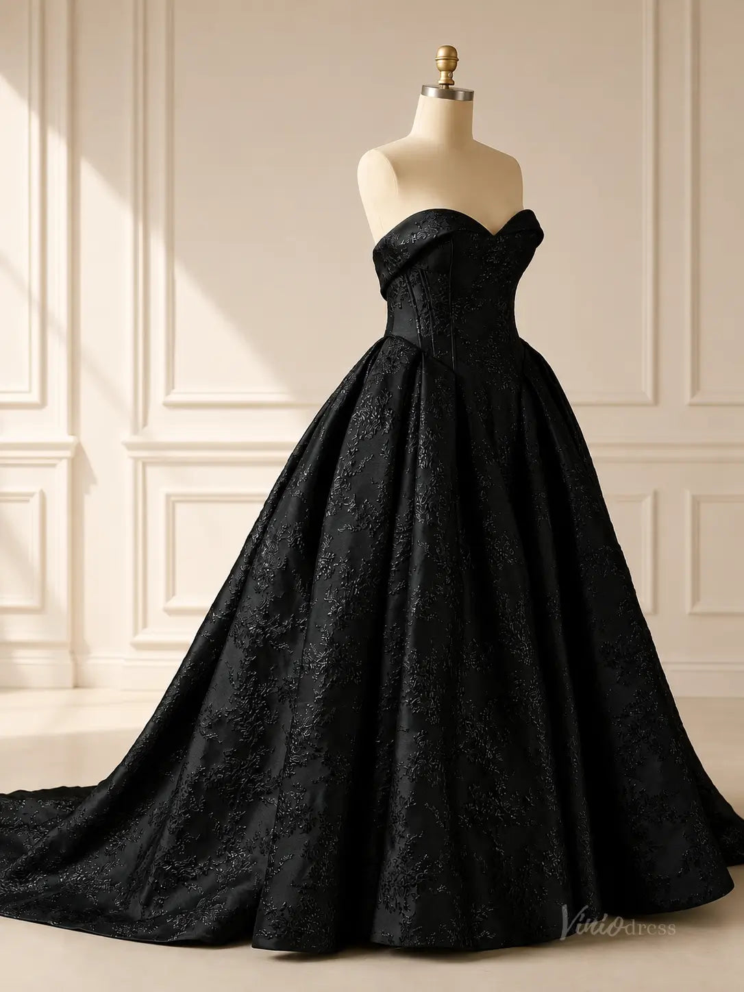 Strapless black jacquard ball gown wedding dress with a sweetheart neckline and intricate floral textured fabric.